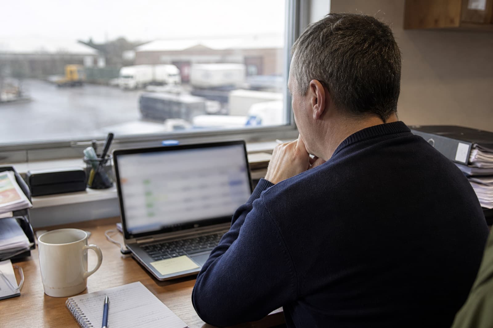 Fleet manager reviewing vehicles and MOT status on a laptop